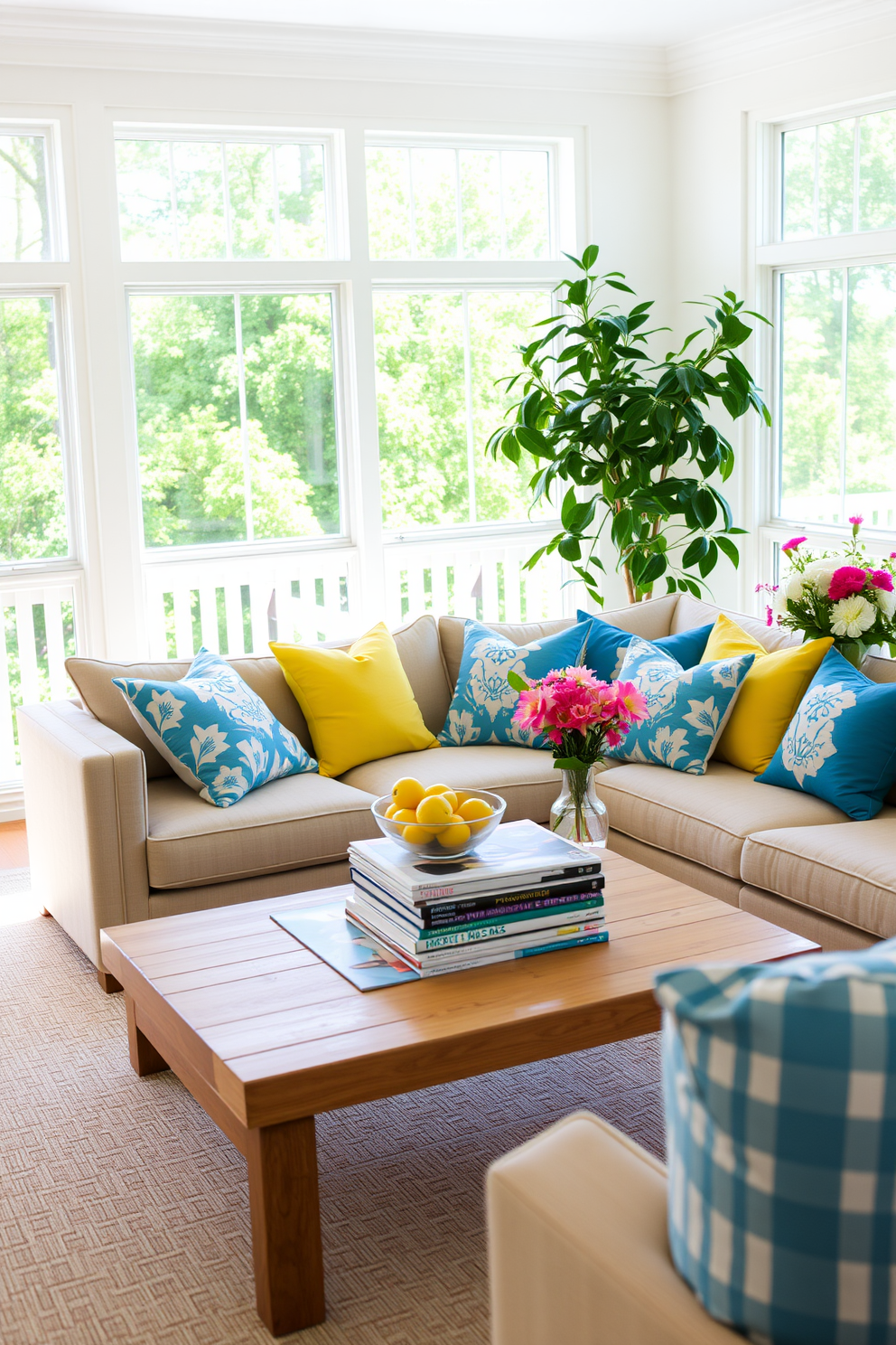 A bright and airy summer living room filled with natural light. The space features a large, comfortable sectional sofa adorned with vibrant throw pillows in shades of yellow and blue. A wooden coffee table sits at the center, topped with a stack of stylish magazines and a decorative bowl of fresh seasonal fruits. In the corner, a tall indoor plant adds a touch of greenery, and a vase of fresh flowers brings a delightful fragrance to the room.