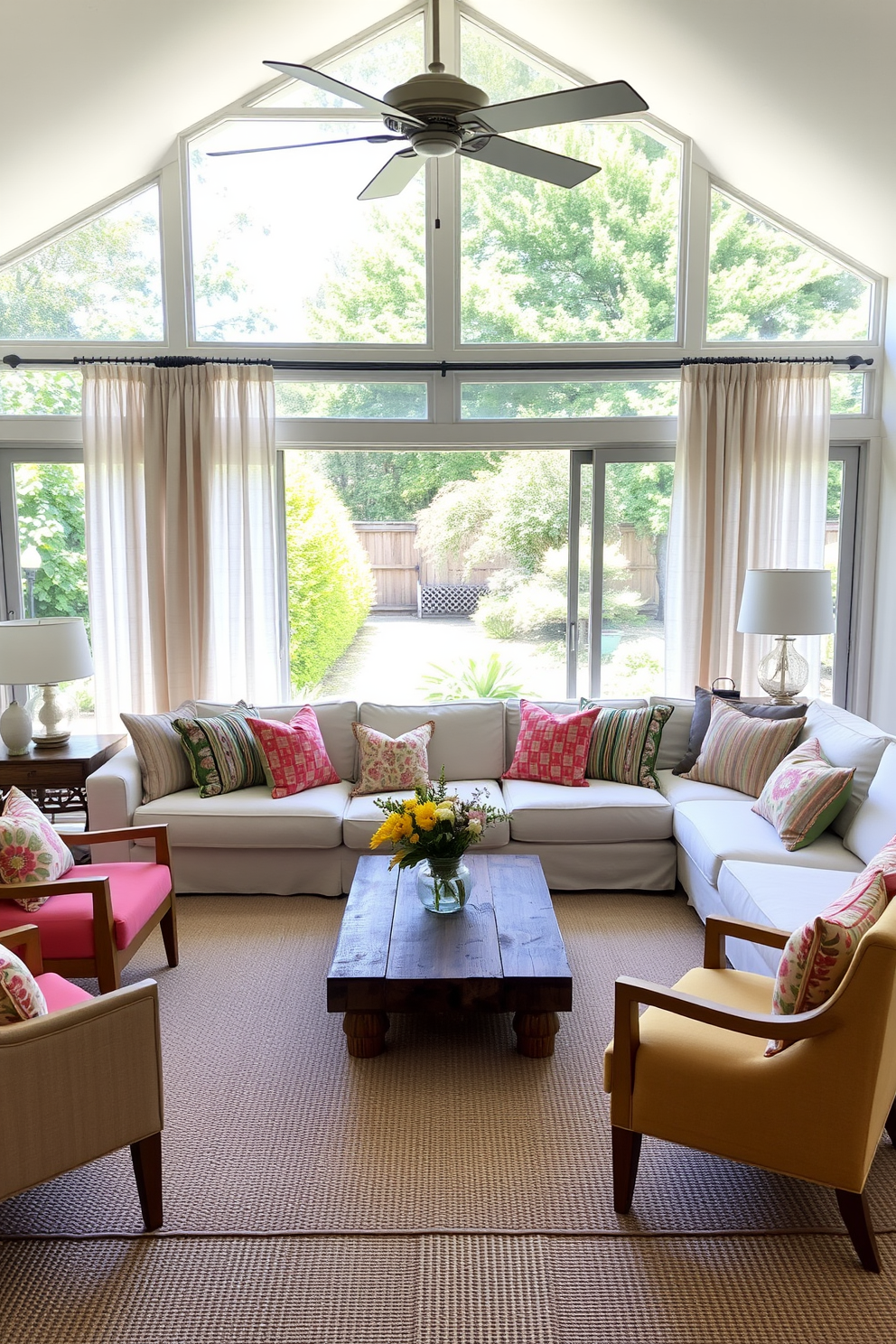 A bright summer living room filled with natural light. Lightweight linen curtains gently flutter in the breeze, framing large windows that overlook a lush garden. The space features a comfortable sectional sofa adorned with colorful throw pillows. A large coffee table made of reclaimed wood sits at the center, surrounded by a few vibrant accent chairs.