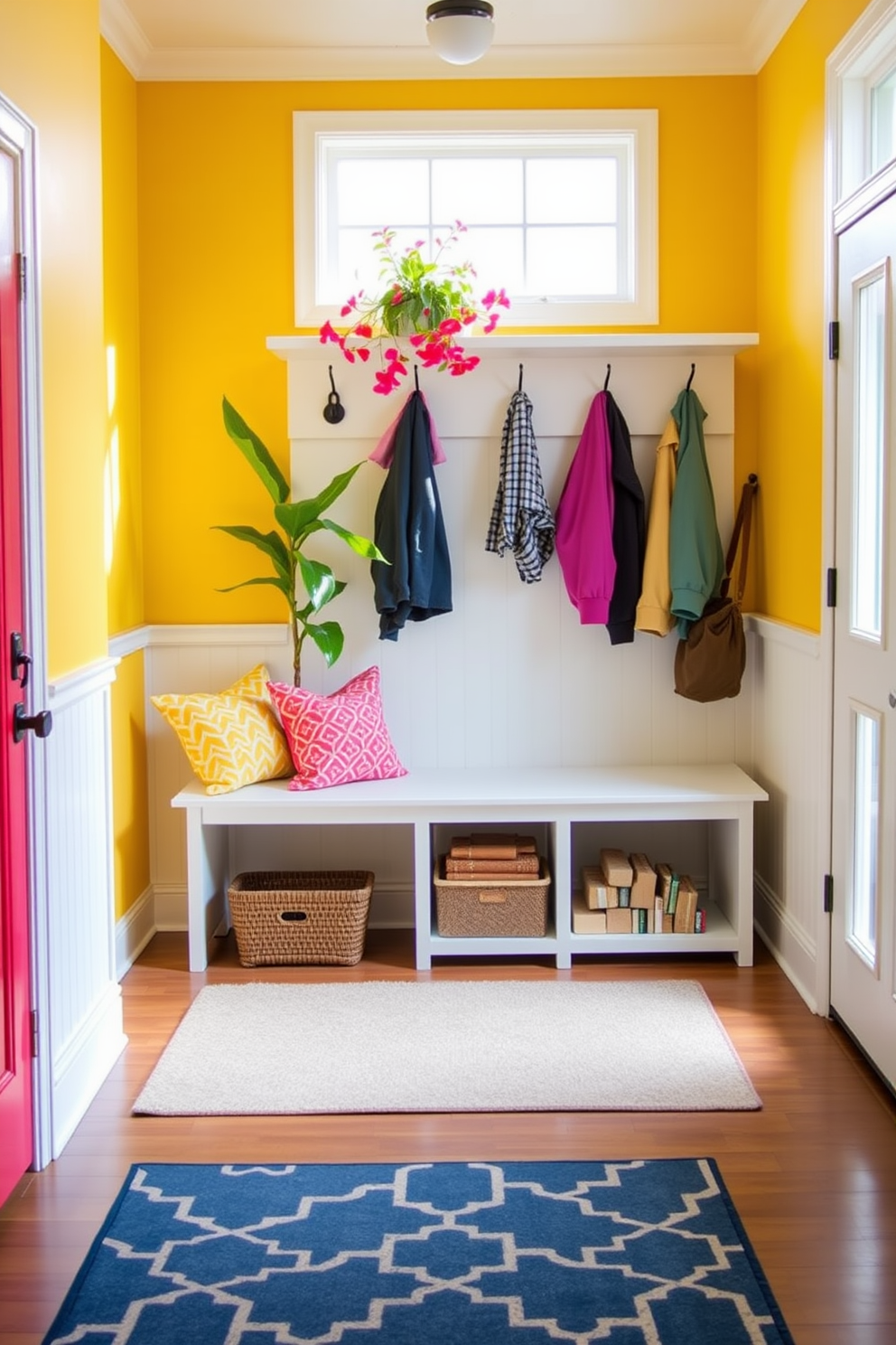 A bright and airy mudroom features a spacious bench with colorful cushions and hooks for hanging jackets. The walls are painted in a cheerful yellow hue, and a vibrant indoor plant adds a refreshing touch to the space. A stylish area rug in a geometric pattern lies beneath the bench, complementing the overall decor. Natural light floods in through a large window, enhancing the welcoming atmosphere of the room.