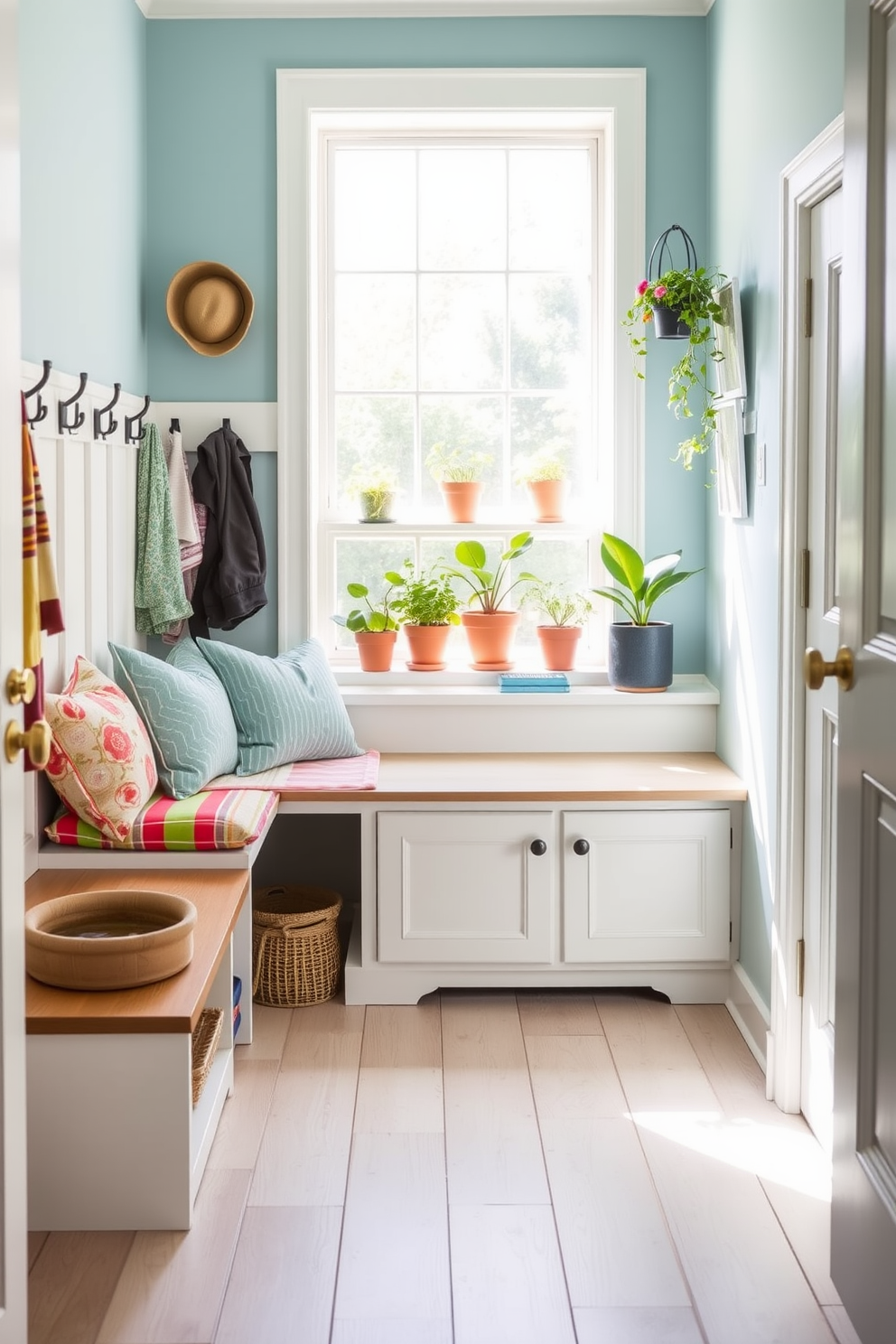 A bright and airy mudroom designed for summer enjoyment features a built-in bench with colorful cushions and hooks for hanging bags and hats. To one side, a small pet area is created with a cozy bed and a stylish water bowl, blending seamlessly with the overall decor. The walls are painted in a soft sky blue, while the floor is adorned with light wood planks that add warmth to the space. Potted plants line the windowsill, bringing in natural light and a refreshing touch of greenery.