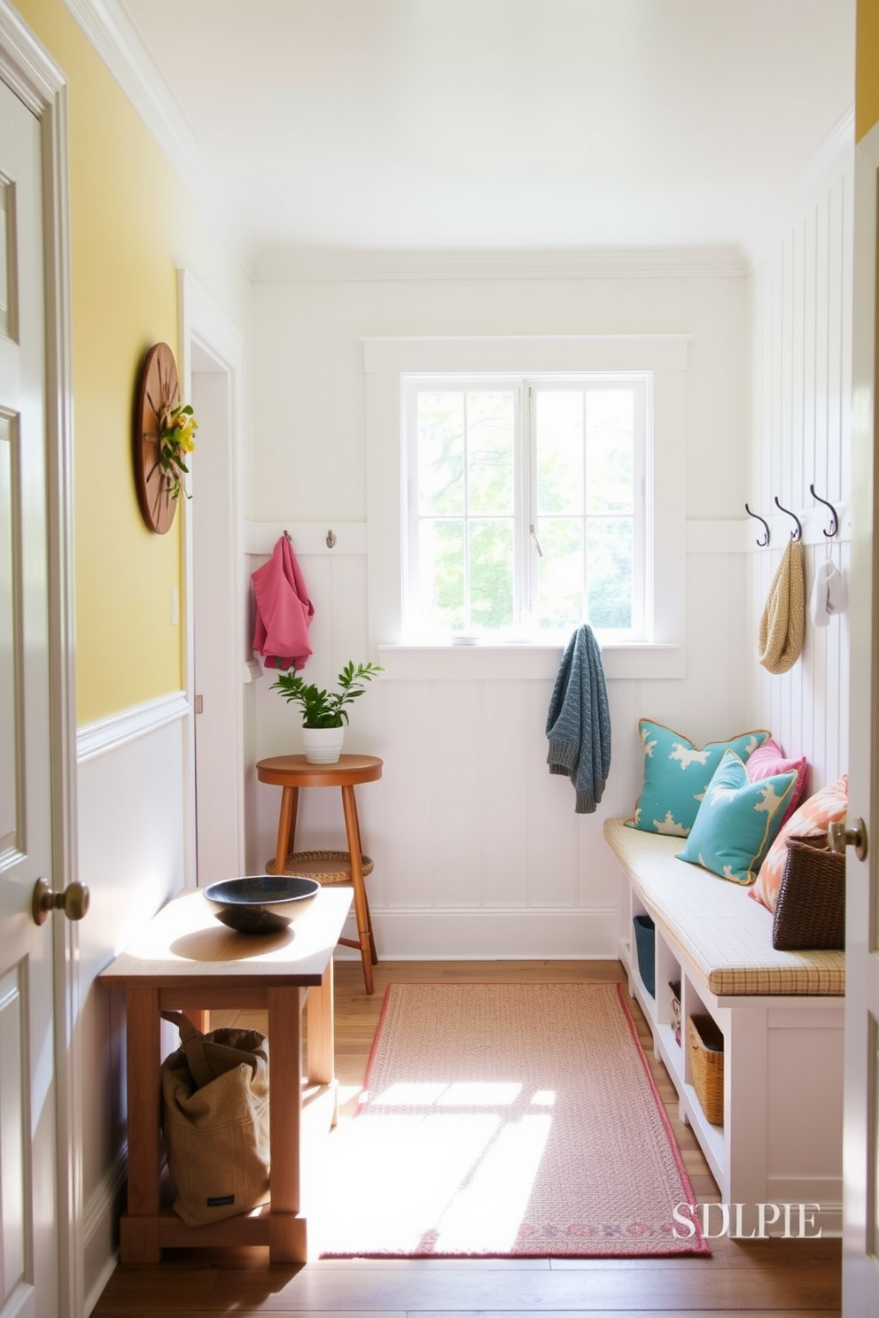 A welcoming summer mudroom features a light and airy atmosphere with soft pastel colors. A small wooden table for keys is positioned near the entrance, adorned with a decorative bowl and a small potted plant. The walls are painted in a crisp white hue, complemented by a cheerful yellow accent wall. Natural light floods the space through a large window, illuminating a cozy bench with colorful cushions and hooks for hanging bags and jackets.