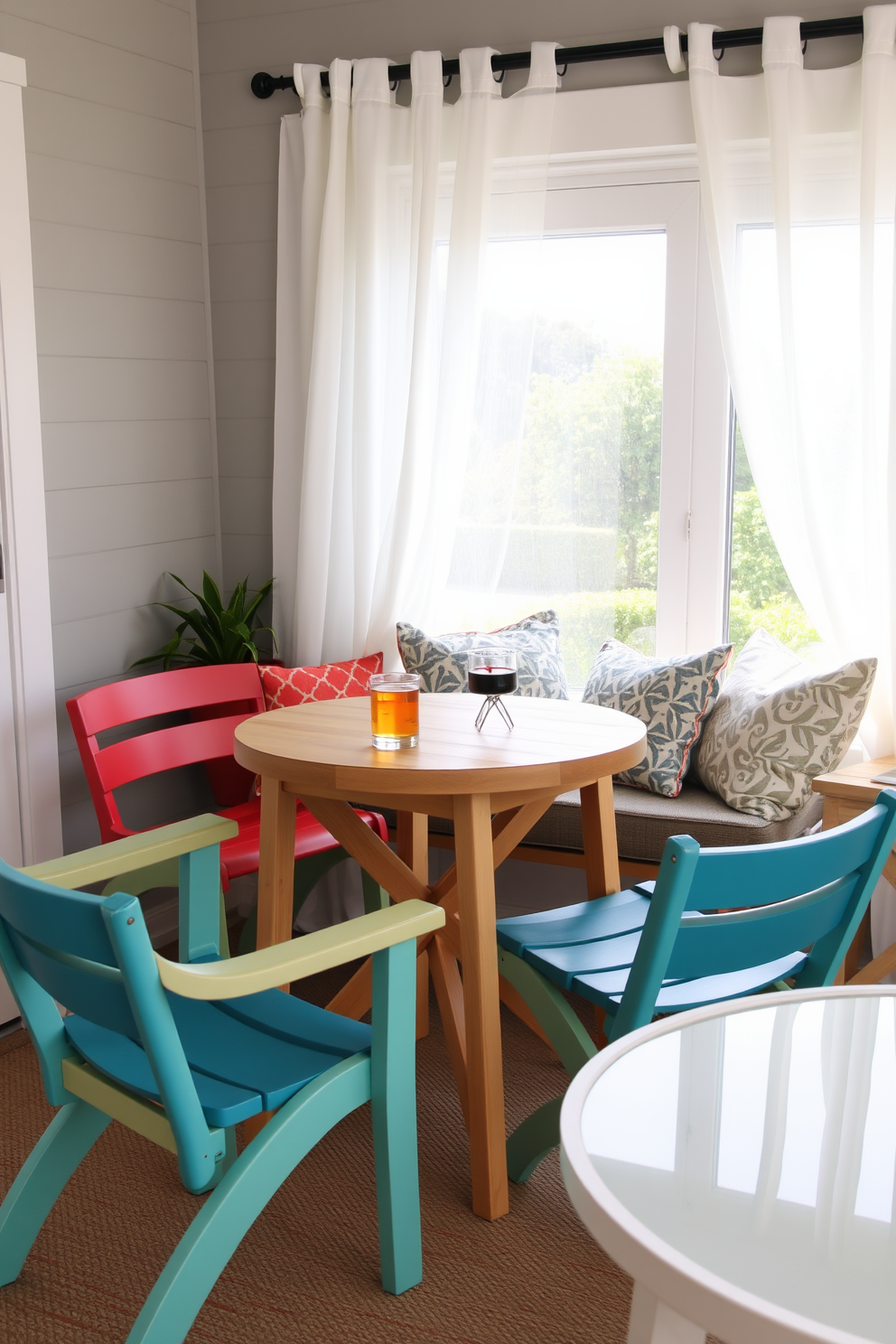 A charming small table for summer drinks. The table is made of light wood with a smooth finish, surrounded by colorful outdoor chairs. A cozy summer reading nook filled with plush cushions. The nook features a large window with sheer white curtains, allowing natural light to flood the space.