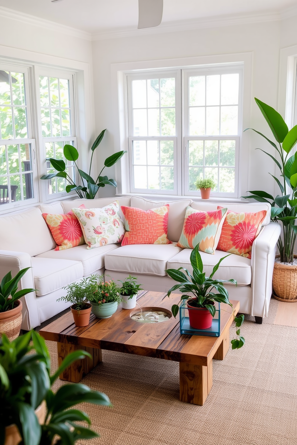 A cozy summer living space featuring a light-colored sofa adorned with vibrant throw pillows. A small coffee table made of reclaimed wood sits in front, surrounded by potted plants that bring a touch of greenery indoors. In one corner, a small water feature gently trickles, creating a serene atmosphere. The walls are painted in soft pastel hues, and natural light floods the room through large windows, enhancing the inviting ambiance.