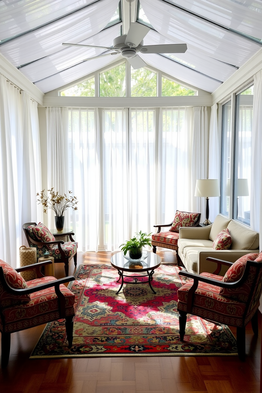 A bright sunroom filled with natural light. The space features large windows adorned with sheer white curtains, allowing the sunlight to filter through softly. In the center of the room, a comfortable seating area is created with a plush sofa and colorful accent chairs. A vibrant area rug anchors the seating, adding warmth and texture to the space.