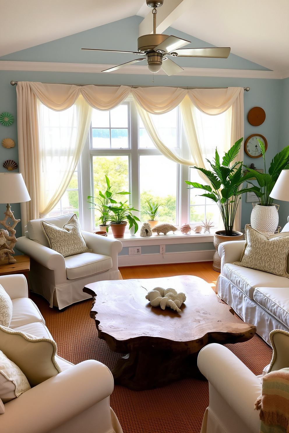 A cozy coastal living room adorned with seashells and driftwood accents. The walls are painted in soft ocean blue, and a large driftwood coffee table sits in the center, surrounded by white slipcovered sofas. Summer window decorations feature light, airy curtains that flutter gently in the breeze. Colorful seashells are arranged on the windowsill, complementing the vibrant greenery of potted plants nearby.