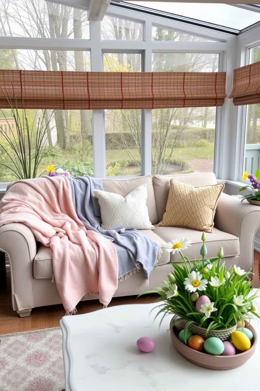 A cozy sunroom decorated for Easter features soft pastel-colored throw blankets draped over a comfortable sofa. The space is adorned with cheerful Easter-themed decorations, including colorful eggs and spring flowers arranged on a coffee table.