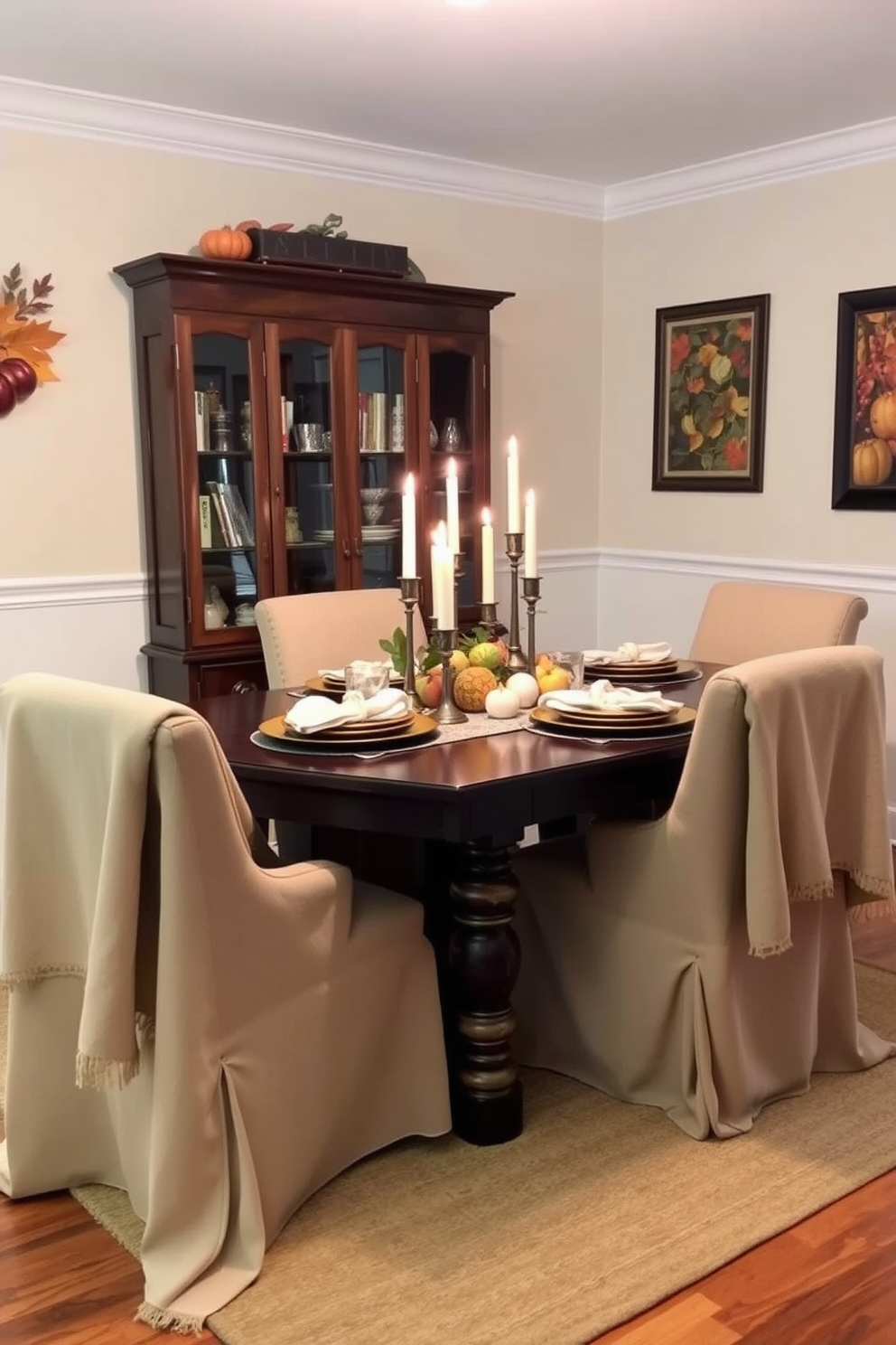 A cozy dining room setting for Thanksgiving. The table is adorned with soft throw blankets draped over the chairs, creating an inviting atmosphere. A centerpiece of seasonal fruits and candles adds warmth to the table. The walls are decorated with autumn-themed artwork, enhancing the festive feel.