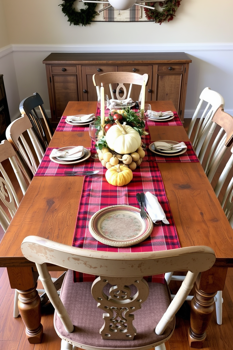 A rustic wooden table is set for a Thanksgiving feast, adorned with plaid runners that add a cozy touch. Surrounding the table are mismatched chairs, each with its own unique charm, inviting guests to gather and celebrate.