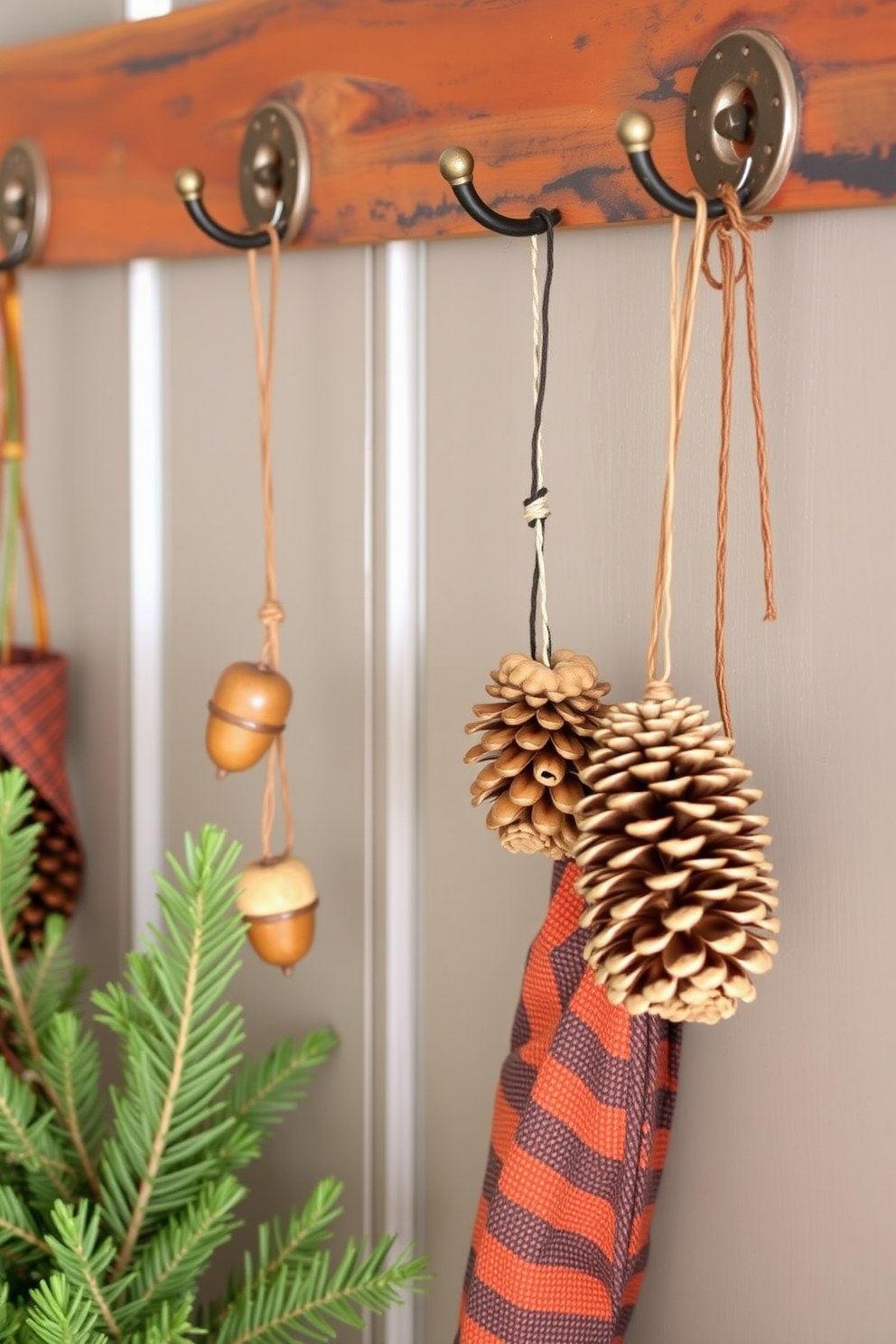 Hanging acorns and pinecones from rustic hooks creates a warm and inviting Thanksgiving entryway. The natural elements add a touch of seasonal charm while complementing a cozy color palette of deep oranges and browns.