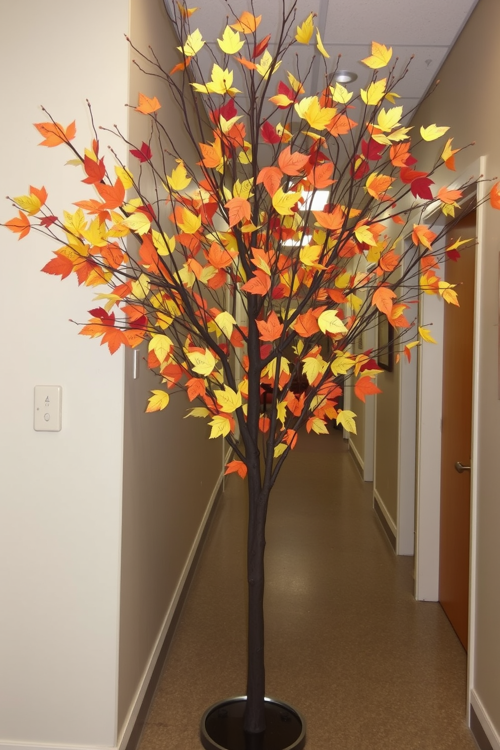 A thankful tree stands in the hallway adorned with branches that stretch elegantly towards the ceiling. Guests are invited to write their messages of gratitude on colorful leaves and hang them on the tree, creating a warm and inviting atmosphere.