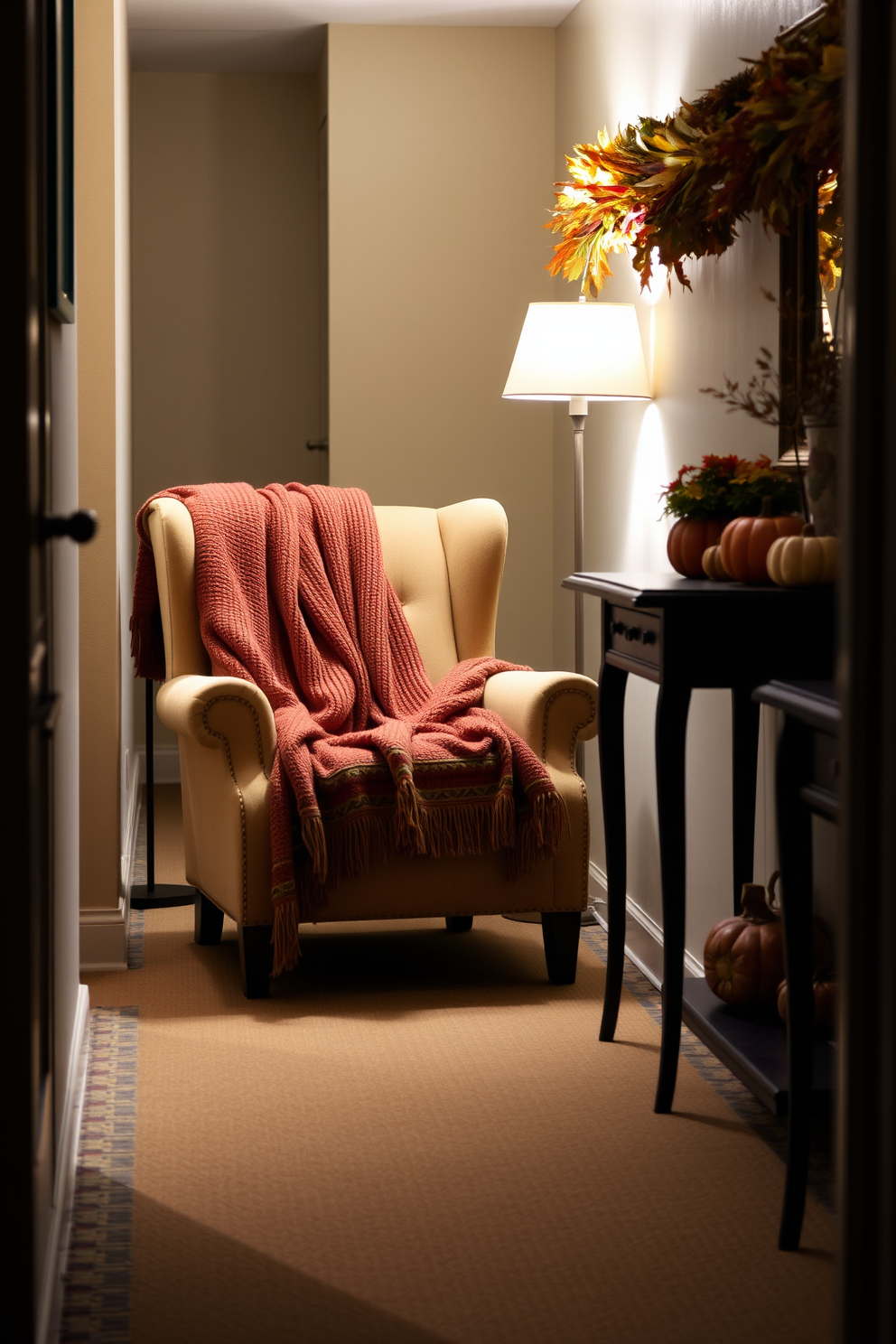 A cozy blanket is draped over a plush armchair situated in a warm and inviting hallway. Soft lighting from a nearby lamp highlights the rich textures of the blanket and the chair, creating a welcoming atmosphere perfect for the Thanksgiving season. The hallway is adorned with seasonal decorations, including small pumpkins and autumn leaves arranged on a console table. A garland of dried corn and colorful foliage runs along the wall, adding a festive touch to the space.