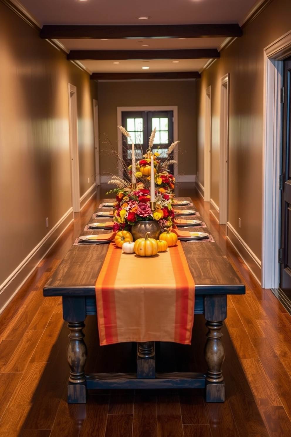 Autumn colored table setting in a hallway featuring a long wooden table adorned with a vibrant tablecloth in shades of orange and gold. Centered on the table is a stunning arrangement of seasonal flowers, pumpkins, and candles that create a warm and inviting atmosphere for Thanksgiving.