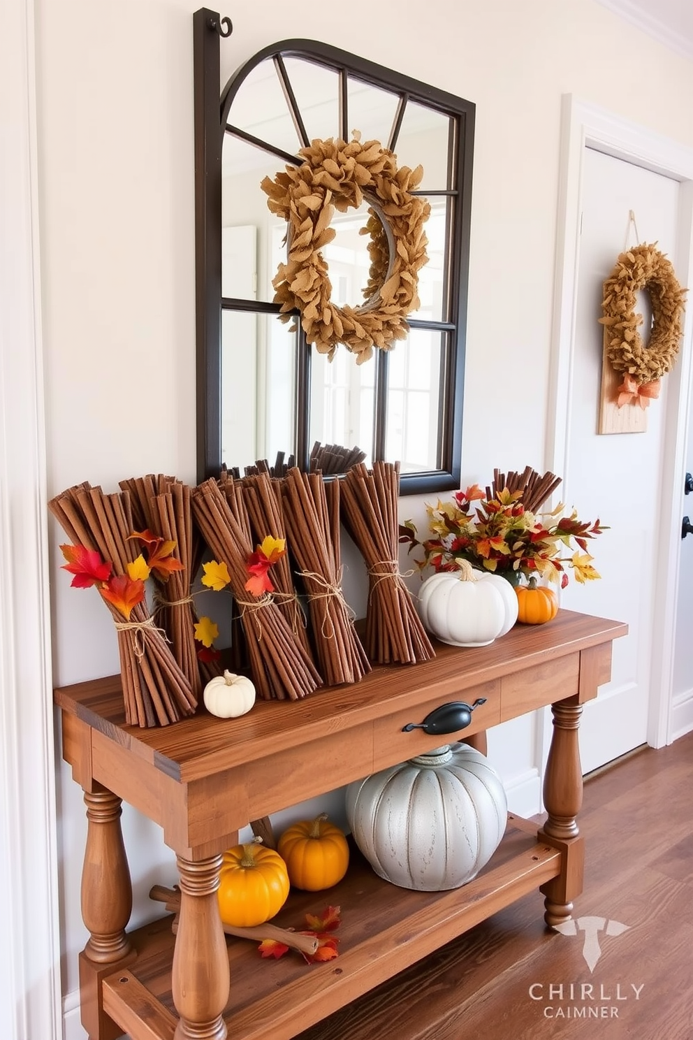 A warm and inviting hallway adorned with bundles of cinnamon sticks tied with twine. The bundles are arranged artfully on a rustic wooden console table, complemented by autumn leaves and small pumpkins.