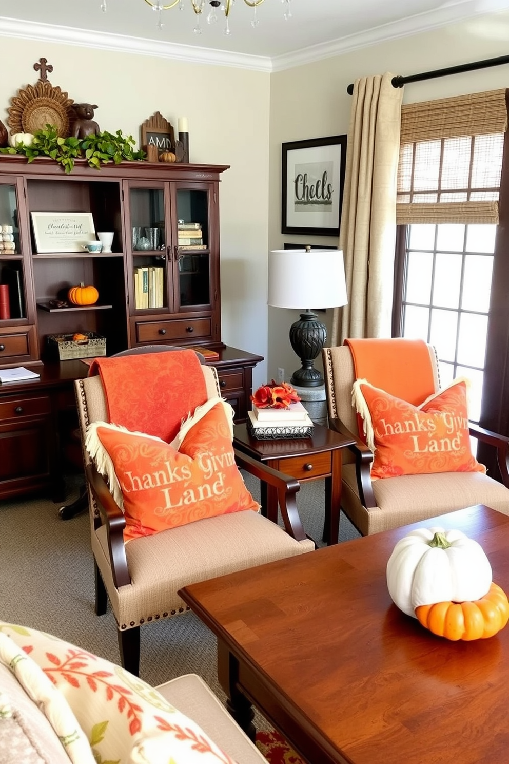 A cozy home office decorated for Thanksgiving features chairs adorned with autumn colored throw pillows in shades of orange, red, and yellow. The warm hues create a welcoming atmosphere, complemented by a rustic wooden desk and a small pumpkin centerpiece on the table.