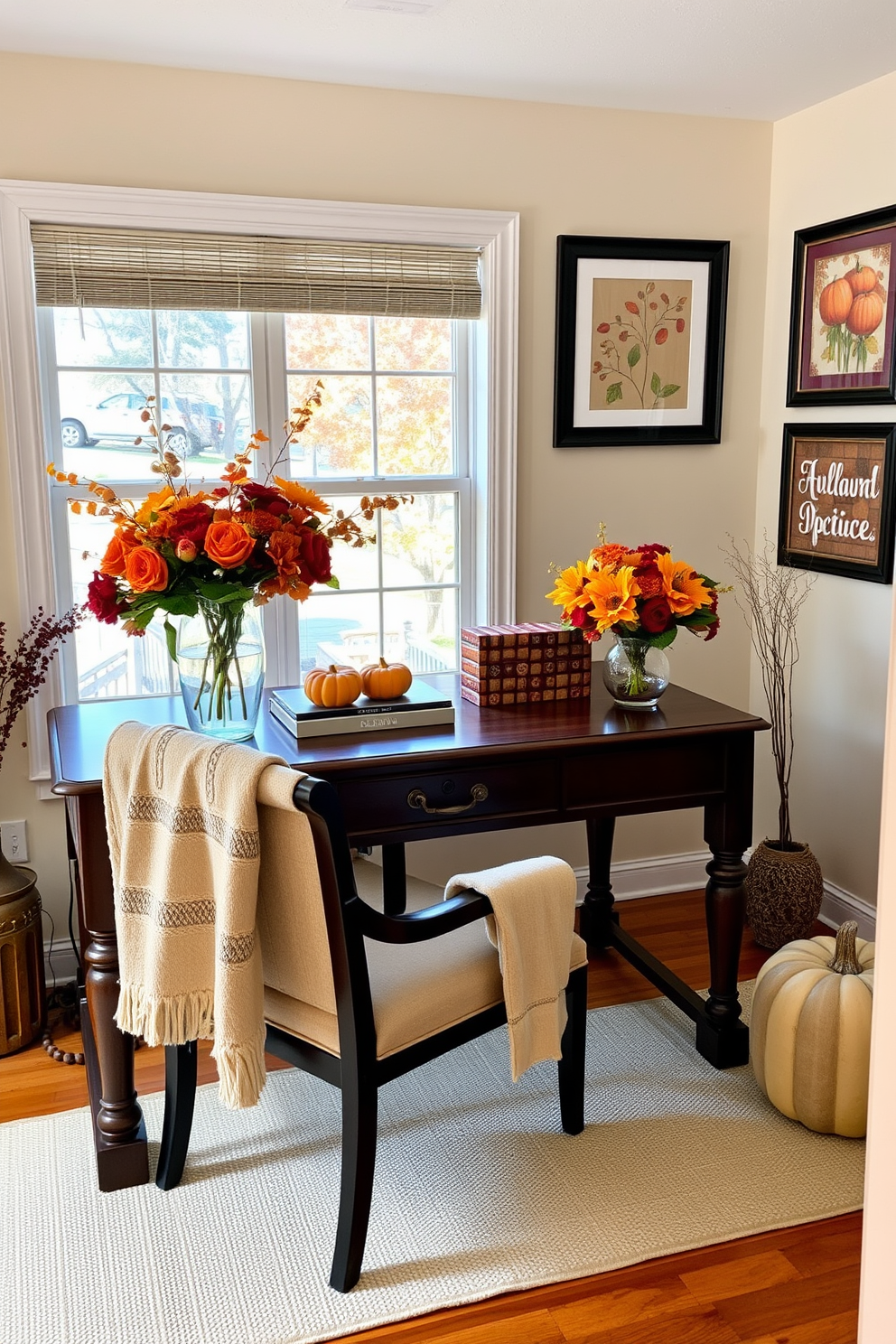 Create a warm and inviting home office space decorated for Thanksgiving. A large wooden desk sits in front of a window, adorned with seasonal floral arrangements in vases featuring autumn colors like deep oranges and rich reds. On the desk, a cozy throw blanket is draped over a comfortable chair, and a small decorative pumpkin adds a festive touch. The walls are painted in a soft cream color, and a few framed autumn-themed artworks are hung to enhance the seasonal ambiance.