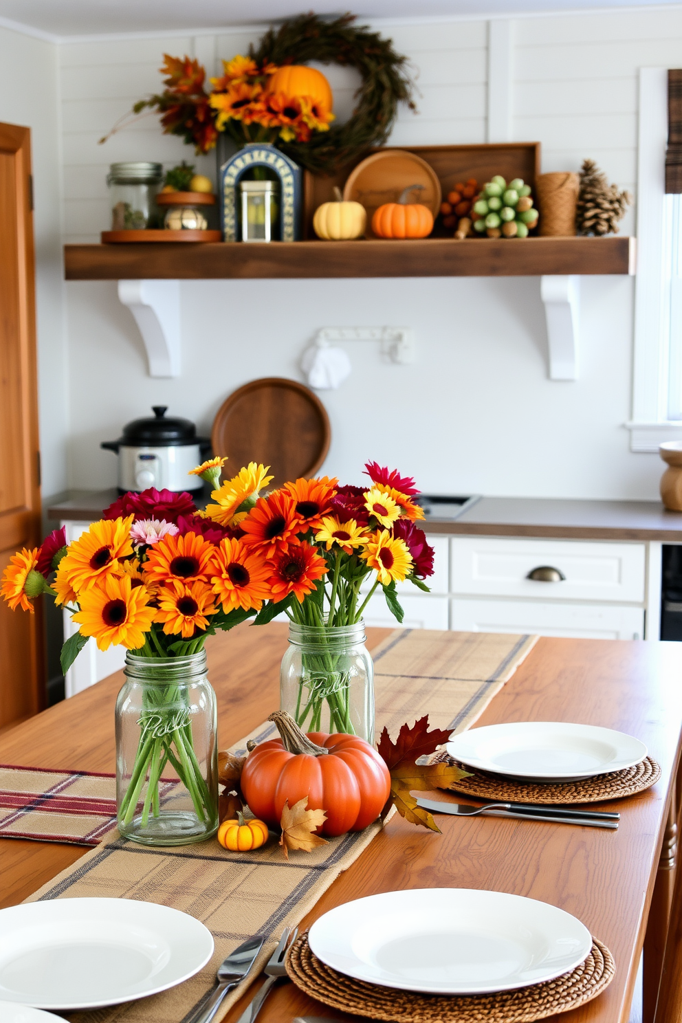 A cozy kitchen adorned for Thanksgiving features mason jars filled with vibrant fall flowers, creating a warm and inviting atmosphere. The rustic wooden shelves are lined with seasonal decor, while a farmhouse table is set with a plaid table runner and autumn-themed dishware.