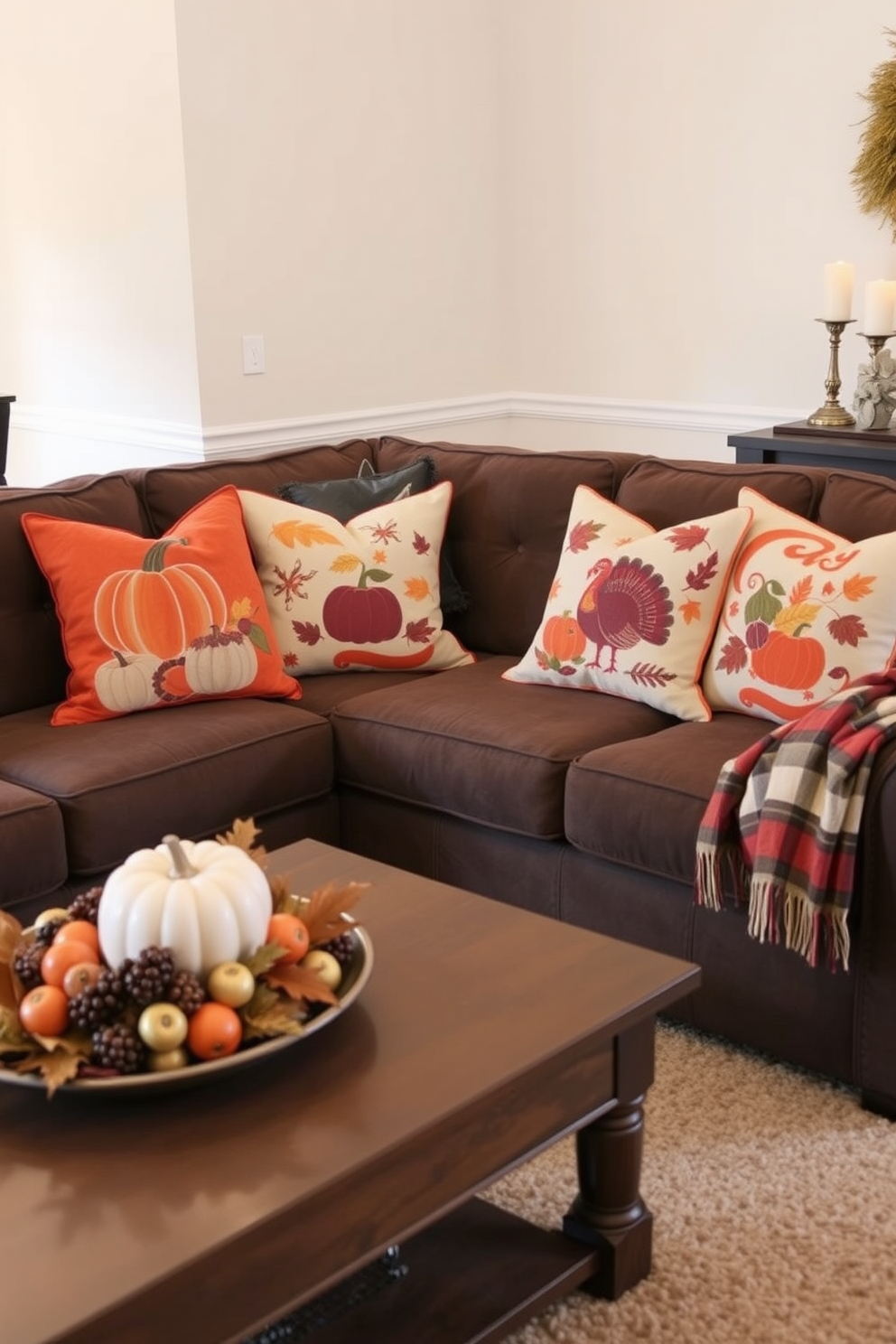 Thanksgiving-themed decorative pillows are arranged on a cozy sectional sofa, featuring warm tones of orange, burgundy, and cream. The pillows showcase various autumn motifs such as pumpkins, leaves, and turkeys, adding a festive touch to the space. The living room is adorned with a harvest-inspired centerpiece on the coffee table, complemented by a soft plaid throw draped over the arm of the sofa. Warm candlelight flickers in the background, creating an inviting atmosphere for family gatherings during the holiday season.