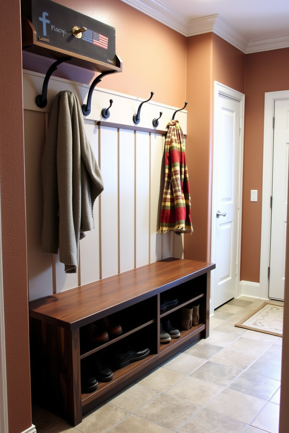 A cozy mudroom features a wooden bench with ample storage space below, perfect for stowing away shoes and seasonal items. The walls are adorned with warm, earthy tones, and decorative hooks hold winter coats and scarves, creating an inviting atmosphere for family and guests.