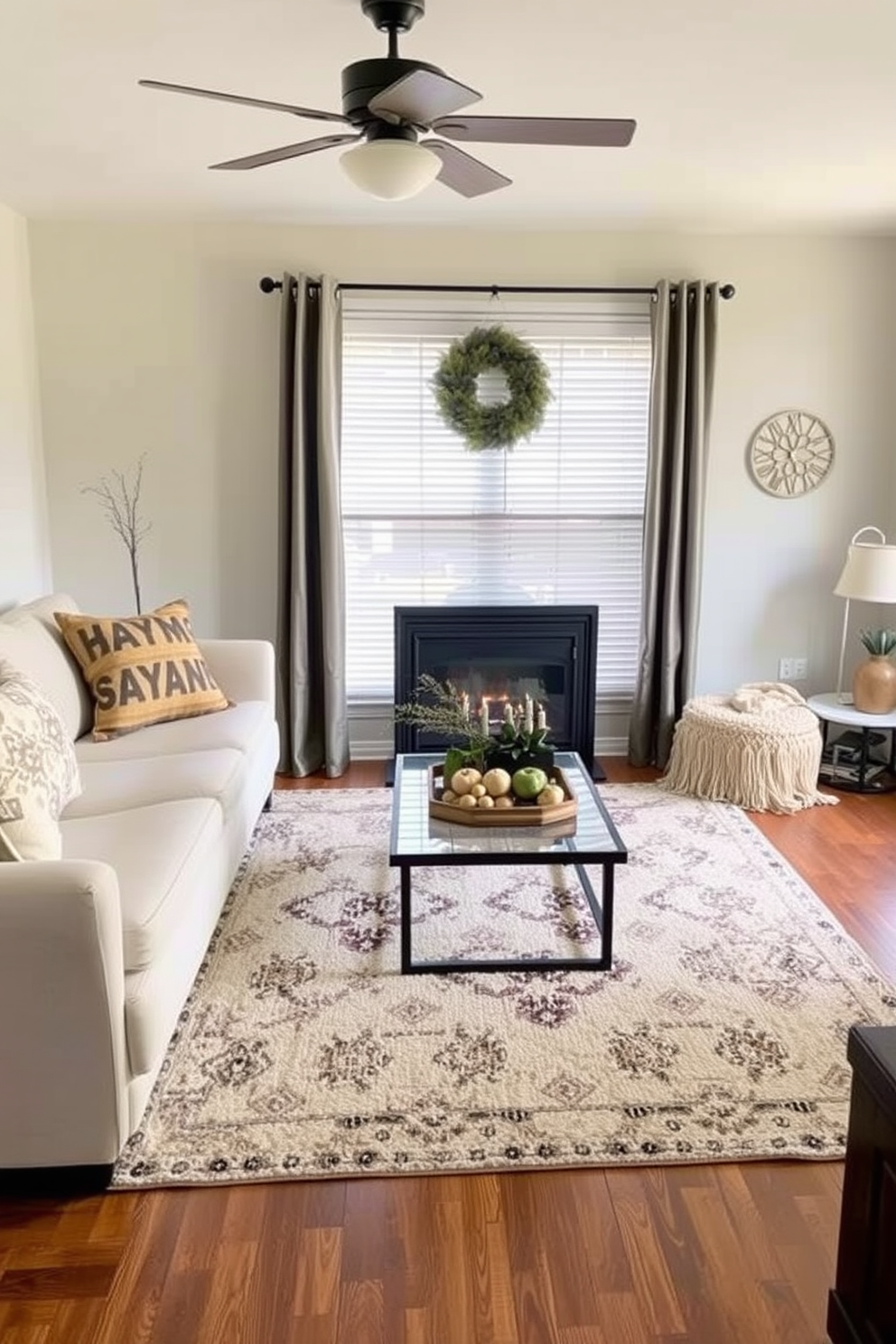 A cozy small living room decorated for Thanksgiving features layered rugs that add warmth and texture to the space. The first rug is a large, soft neutral base, while a smaller, patterned rug sits on top, creating a visually appealing contrast.