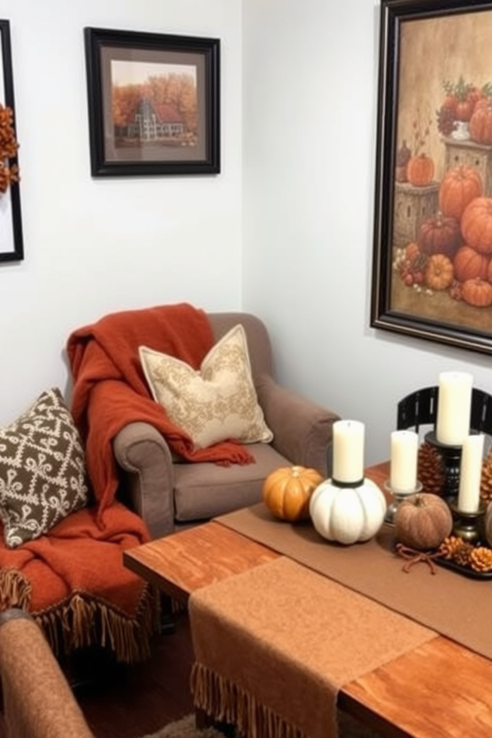 A cozy Thanksgiving-themed small space decorated with rich textiles. Soft throw blankets in warm autumn colors drape over a plush armchair, while decorative pillows add comfort and style to the seating area. A small dining table is set with a rustic table runner and seasonal centerpieces featuring pumpkins and candles. The walls are adorned with framed autumn-themed artwork, enhancing the inviting atmosphere.