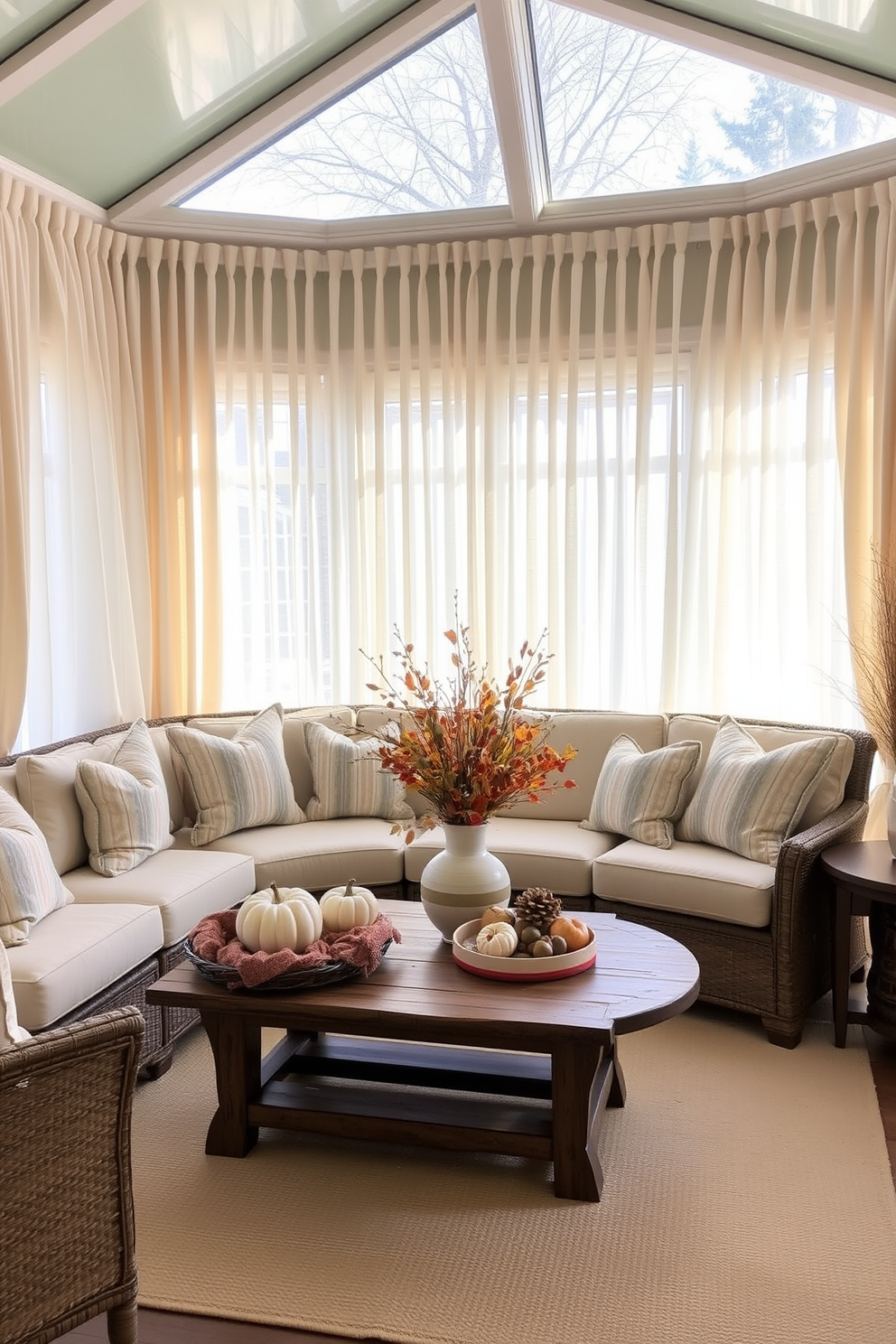 A sunroom adorned with soft neutral curtains that gracefully filter natural light. The space features a cozy seating area with plush cushions and a rustic wooden coffee table surrounded by seasonal decorations for Thanksgiving.