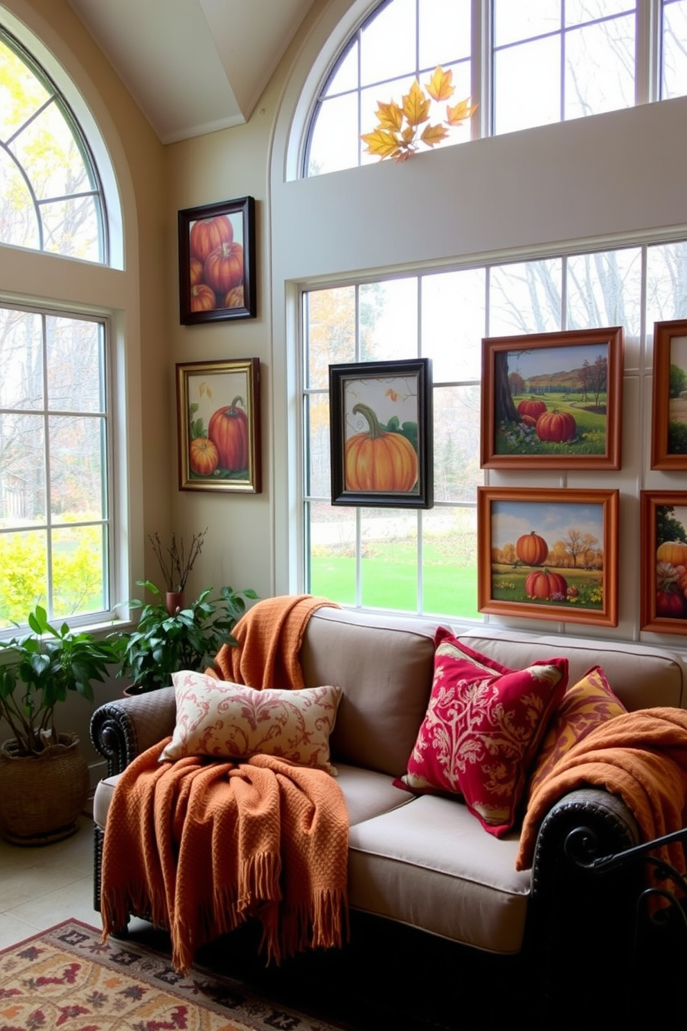 A cozy sunroom adorned with harvest-themed wall art and prints. The walls feature vibrant autumn colors with framed artwork depicting pumpkins, leaves, and seasonal landscapes. A comfortable seating area includes a plush sofa draped with warm blankets. Decorative pillows in fall hues complement the space, creating an inviting atmosphere for gatherings.