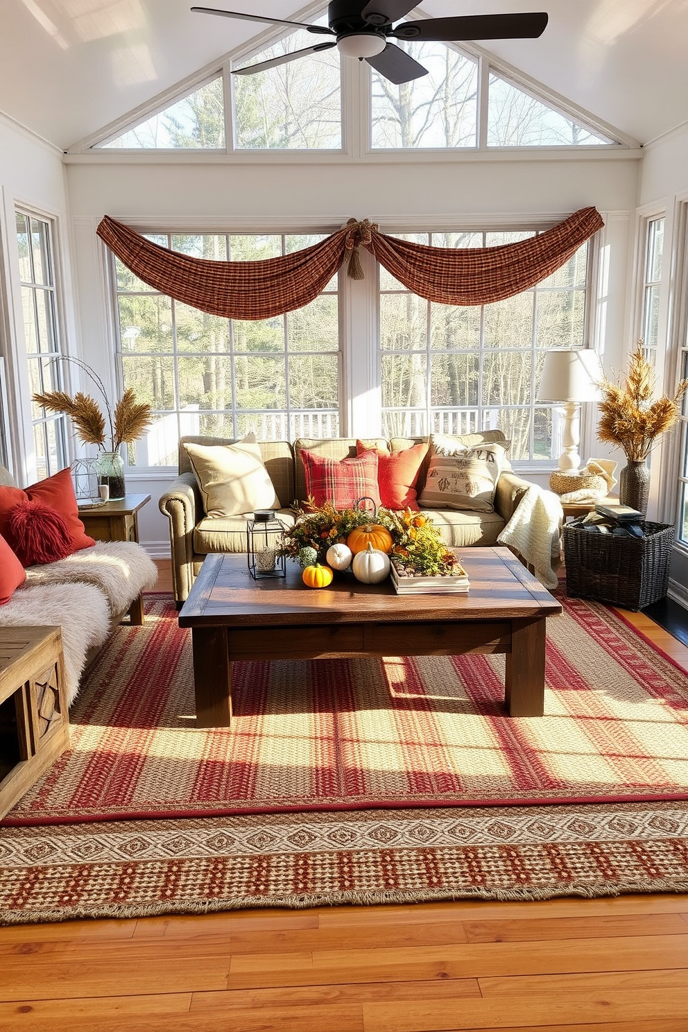 A cozy sunroom filled with natural light. Layered rugs in warm earthy tones create a textured foundation on the hardwood floor, enhancing the inviting atmosphere. Plush cushions in autumn colors are scattered across a comfortable seating area. A rustic wooden coffee table holds a centerpiece of seasonal decor, celebrating the spirit of Thanksgiving.