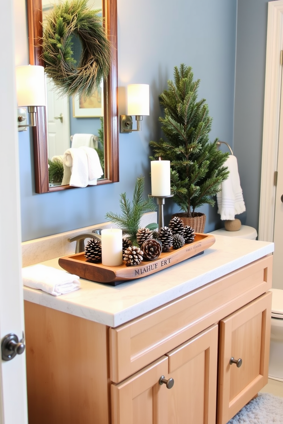 A cozy winter bathroom setting featuring pinecone centerpieces. The vanity is adorned with a rustic wooden tray holding several pinecones, complemented by soft white candles and a small evergreen sprig. The walls are painted in a cool blue hue, evoking a serene winter atmosphere. Plush white towels are neatly arranged, and a fluffy rug adds warmth to the space, creating a perfect retreat for the season.