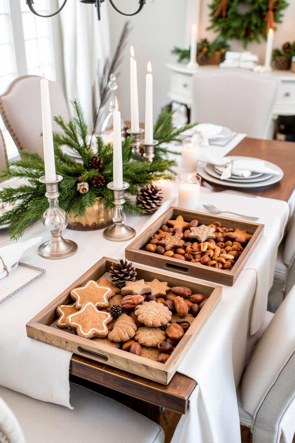 A beautifully styled dining room adorned for winter. The table is set with decorative trays filled with an assortment of seasonal treats like gingerbread cookies and spiced nuts. Soft white table linens drape elegantly across the table, complemented by rustic wooden accents. Flickering candlelight adds warmth to the atmosphere, while evergreen branches and pinecones are artfully arranged as centerpieces.