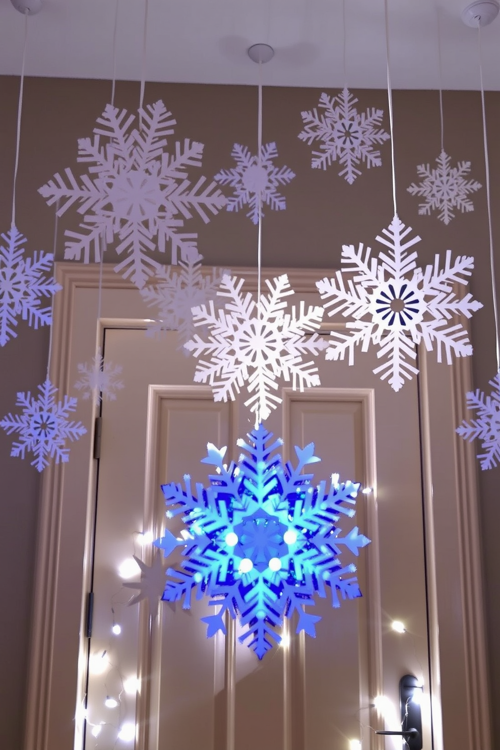 Giant snowflakes cut from cardstock hang gracefully from the ceiling, creating a whimsical winter wonderland effect. The front door is adorned with a large snowflake wreath, surrounded by twinkling fairy lights that enhance the festive atmosphere.