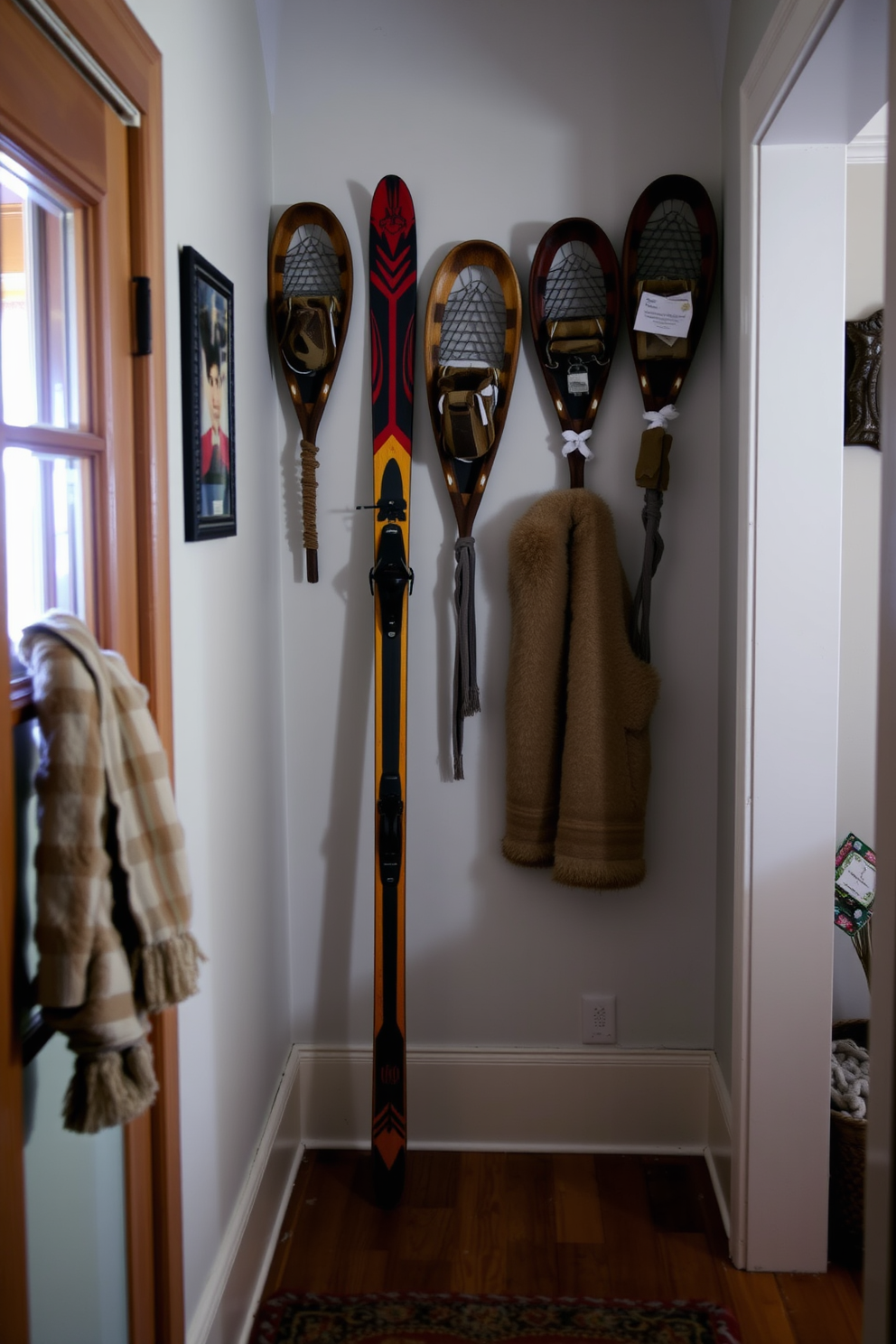 A cozy winter hallway featuring vintage skis leaning against the wall. Snowshoes are mounted as wall decor, adding rustic charm to the space.