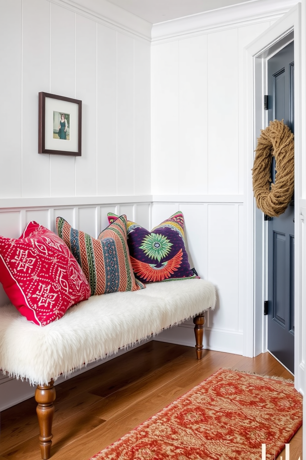 Colorful accent pillows are scattered across a plush bench in the winter hallway, adding warmth and vibrancy to the space. The walls are adorned with soft white paneling, while a cozy runner rug complements the inviting atmosphere.