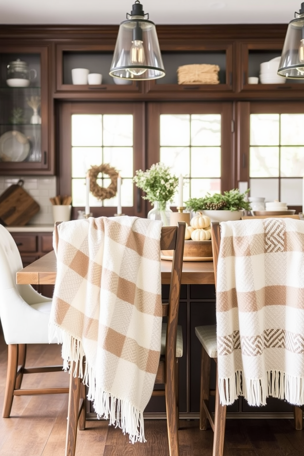 Cozy throw blankets draped over the backs of rustic wooden kitchen chairs create an inviting atmosphere. Soft textures and warm colors enhance the winter kitchen decor, making it a perfect gathering spot.