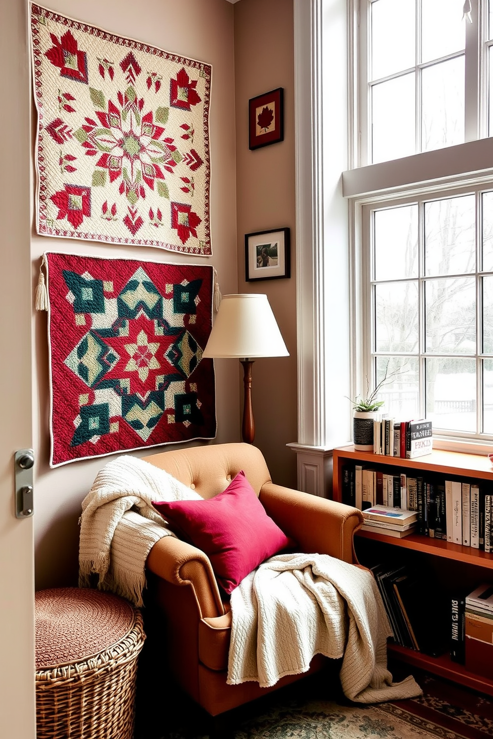 A cozy winter reading nook featuring quilted wall hangings that add warmth and texture to the space. A plush armchair is positioned next to a small wooden side table, inviting relaxation with a soft blanket draped over the arm. Natural light filters through a large window, illuminating a collection of books neatly arranged on a nearby shelf. A warm color palette of deep reds and soft creams creates a welcoming atmosphere perfect for curling up with a good book.