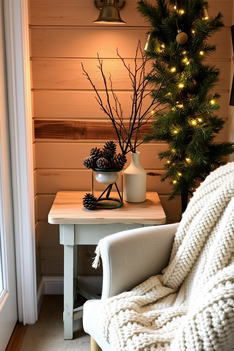 A cozy winter nook featuring natural elements like pinecones and branches. The space is adorned with a small, rustic wooden table topped with a cluster of pinecones and a few branches in a simple vase. Soft, warm lighting enhances the atmosphere, creating a welcoming vibe. A plush throw blanket drapes over a nearby chair, inviting you to curl up and enjoy the seasonal decor.